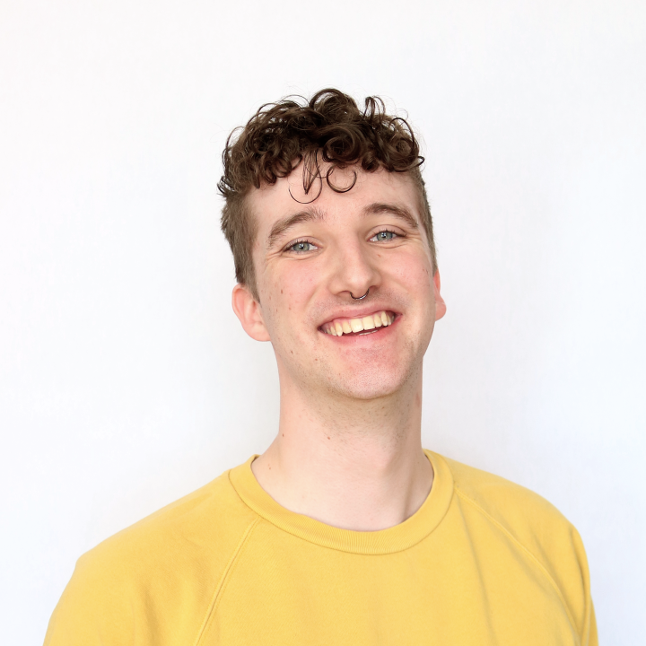 Steph smiles at you with his head tilted slightly back. He's wearing his favourite yellow sweater.
